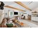 Bright living room with exposed beams, leather couch, and a workspace at 5107 27Th S Ave, Gulfport, FL 33707