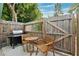 Small patio with wooden table and chairs plus a gas grill at 5107 27Th S Ave, Gulfport, FL 33707