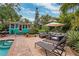 Inviting pool area with patio furniture and lush tropical landscaping at 5107 27Th S Ave, Gulfport, FL 33707