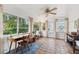 Sunroom with terracotta tile floor, wood desk, and large windows offering natural light at 5107 27Th S Ave, Gulfport, FL 33707
