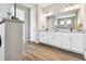 Modern bathroom with double vanity, white cabinets, and tile flooring at 5226 Lake Venice Dr, Wimauma, FL 33598