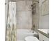 Bathroom with tub shower, gray tile, and decorative shower curtain at 5226 Lake Venice Dr, Wimauma, FL 33598
