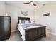 Cozy bedroom with dark wood bed frame and ceiling fan at 5226 Lake Venice Dr, Wimauma, FL 33598