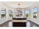 Bright dining room with large windows, wooden table, and bench seating at 5226 Lake Venice Dr, Wimauma, FL 33598