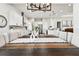 Elegant dining room showcasing a long wooden table and modern chandelier at 5226 Lake Venice Dr, Wimauma, FL 33598
