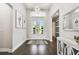 Spacious foyer with hardwood floors, chandelier, and view to living room at 5226 Lake Venice Dr, Wimauma, FL 33598