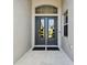 Double front doors with glass panels and a decorative arch at 5226 Lake Venice Dr, Wimauma, FL 33598