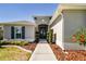 Front entry with walkway, landscaping, and double doors at 5226 Lake Venice Dr, Wimauma, FL 33598