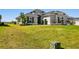 House exterior showcasing landscaping and a large front yard at 5226 Lake Venice Dr, Wimauma, FL 33598