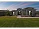House exterior at dusk, featuring a walkway and landscaping at 5226 Lake Venice Dr, Wimauma, FL 33598