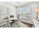 Home office with window, hardwood floors, and white furniture at 5226 Lake Venice Dr, Wimauma, FL 33598