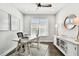 Home office with a desk, window, and hardwood floors at 5226 Lake Venice Dr, Wimauma, FL 33598