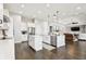 Open concept kitchen features island, stainless steel appliances, and hardwood floors at 5226 Lake Venice Dr, Wimauma, FL 33598