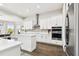 Modern kitchen with white cabinets, stainless steel appliances, and an island at 5226 Lake Venice Dr, Wimauma, FL 33598