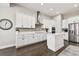 Modern kitchen with white cabinets, stainless steel appliances, and an island at 5226 Lake Venice Dr, Wimauma, FL 33598