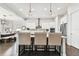 Kitchen island with seating, modern lighting and view to dining area at 5226 Lake Venice Dr, Wimauma, FL 33598
