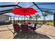 Relaxing pool and patio area with covered seating and outdoor kitchen at 5226 Lake Venice Dr, Wimauma, FL 33598