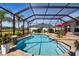 Inviting freeform swimming pool with a screened enclosure at 5226 Lake Venice Dr, Wimauma, FL 33598