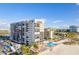Oceanfront condo building showcasing pool and beach access at 5396 Gulf Blvd # 605, St Pete Beach, FL 33706