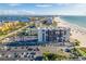 Aerial view of beachfront condo building with parking and ocean views at 5396 Gulf Blvd # 605, St Pete Beach, FL 33706