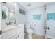 Updated bathroom with white vanity, toilet and shower at 5396 Gulf Blvd # 605, St Pete Beach, FL 33706