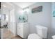 Guest bathroom with white vanity and toilet at 5396 Gulf Blvd # 605, St Pete Beach, FL 33706