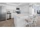 Modern white kitchen with stainless steel appliances at 5396 Gulf Blvd # 605, St Pete Beach, FL 33706