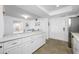 White kitchen with breakfast bar and stainless steel appliances at 5396 Gulf Blvd # 605, St Pete Beach, FL 33706