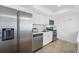 Stainless steel appliances and white cabinetry in kitchen at 5396 Gulf Blvd # 605, St Pete Beach, FL 33706