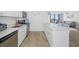 Modern kitchen with white cabinets and breakfast bar at 5396 Gulf Blvd # 605, St Pete Beach, FL 33706