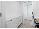 White home office with storage and view to hallway at 5396 Gulf Blvd # 605, St Pete Beach, FL 33706