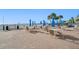 Community patio area with tables, chairs, and umbrellas at 5396 Gulf Blvd # 605, St Pete Beach, FL 33706