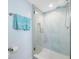 Glass shower with white tile and penny round floor at 5396 Gulf Blvd # 605, St Pete Beach, FL 33706