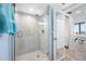 Walk-in shower with glass enclosure and marble tile at 5396 Gulf Blvd # 605, St Pete Beach, FL 33706