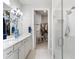 Elegant bathroom with double vanity, walk-in shower, and large closet at 5519 Blue Crush Bnd, Land O Lakes, FL 34638