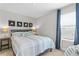 Cozy bedroom with a comfortable queen-size bed and beachy decor at 5519 Blue Crush Bnd, Land O Lakes, FL 34638