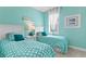 Charming bedroom with twin beds and light teal walls at 5519 Blue Crush Bnd, Land O Lakes, FL 34638
