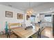 Dining area with light wood table, bench seating, and kitchen access at 5519 Blue Crush Bnd, Land O Lakes, FL 34638