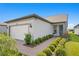 Single-story home with attached garage and landscaped front yard at 5519 Blue Crush Bnd, Land O Lakes, FL 34638