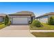 Two-car garage and well-maintained landscaping at 5519 Blue Crush Bnd, Land O Lakes, FL 34638