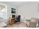 Bright home office with wood desk, comfortable chair, and large window at 5519 Blue Crush Bnd, Land O Lakes, FL 34638