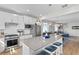 Spacious kitchen island with gray countertop, stainless steel appliances, and open layout at 5519 Blue Crush Bnd, Land O Lakes, FL 34638