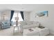 Relaxing living room featuring a comfy couch and large windows at 5519 Blue Crush Bnd, Land O Lakes, FL 34638