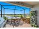 Screened patio with lake view, dining area, and bar at 5519 Blue Crush Bnd, Land O Lakes, FL 34638
