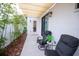 Relaxing back patio with seating area, shade cover, and lush bamboo plants at 5980 Central Ave, New Port Richey, FL 34653