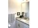 Bathroom with granite countertop, white cabinets and decorative accents at 5980 Central Ave, New Port Richey, FL 34653