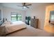 Bedroom featuring a queen bed, dresser, and large window at 5980 Central Ave, New Port Richey, FL 34653
