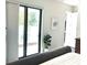 Bedroom with sliding glass doors leading to a private patio at 5980 Central Ave, New Port Richey, FL 34653