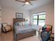 Spacious bedroom with a ceiling fan and large window at 5980 Central Ave, New Port Richey, FL 34653
