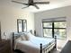 Bright bedroom with a queen bed and large window at 5980 Central Ave, New Port Richey, FL 34653